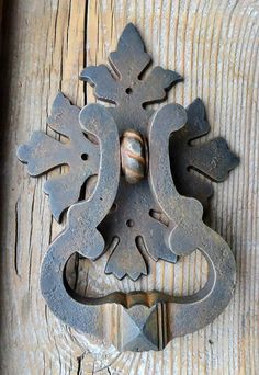 an old door handle on a wooden door