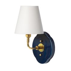 a blue and gold wall light with a white shade on the lamp fixture, against a white background