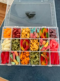 a plastic container filled with lots of different types of candies in it's compartments