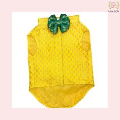 a yellow shirt with a green bow on it