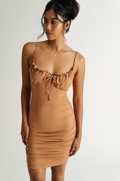 Stay cute in the Dani Toffee Brown Ribbed Ruched Bodycon Mini Dress. This bodycon party dress features a ruched design, adjustable front tie, and ruffle bust trim. Ruched Fitted Mini Dress With Ruffled Straps, Fitted Ruched Mini Dress With Ruffled Straps, Fitted Mini Dress With Ruched Details And Ruffled Straps, Brown Ruched Mini Dress For Date Night, Brown Ruched Bodycon Dress For Date Night, Brown Ruched Mini Bodycon Dress, Casual Date Night Dress, V Neck Flowy Dress, Emerald Dress