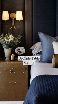 a bed room with a neatly made bed and two lamps on the wall above it