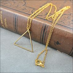 Tender necklace with a tender pendant. Geometric golden triangle motif.  Side: 2.4cm Necklace golden 60 cm  The length can be changed, if desired. Minimalist Gold Metal Necklace, Gold Geometric Brass Jewelry, Gold-tone Brass Minimalist Chain Necklace, Minimalist Gold-tone Brass Chain Necklace, Minimalist Gold Pendant Chain Necklace, Minimalist Gold-tone Brass Necklace, Minimalist Triangle Metal Necklace, Gold Triangle Metal Jewelry, Minimalist Delicate Brass Chain Necklace