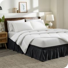 a bed with white sheets and black ruffled bedspread in a bedroom setting