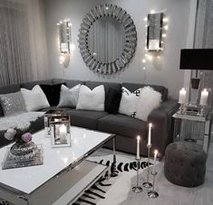 a living room filled with furniture and candles