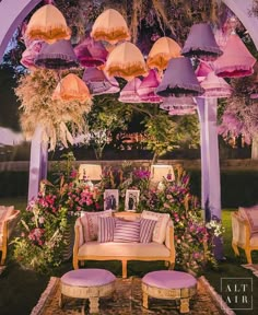 an outdoor seating area with pink and yellow umbrellas over it's headlight