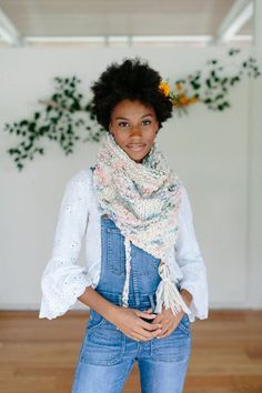 a woman wearing overalls and a scarf