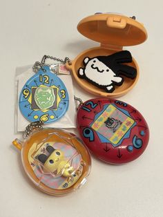 there are four different key chains in the box and one has a cartoon character on it