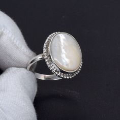 Welcome to your Shop Shop Link : https://uniquejewelstudio.etsy.com Stone: Mother Of Pearl Gemstone Shape: Oval Shape Ring Size:- All Size Ring Weight : 3 to 8 gm Metal:- Pure 925 Sterling Silver Jewelry Type:- Ring Stock Code : SR-1068 Benefits of Mother's Of Pearl, Wearing Mother Of Pearl as jewelry is beneficial to the soft tissue, muscle tissue, heart, and joints. It will help you connect with the power of water, providing calming and subtle energy. This will help to guard you against negati Fine Jewelry Sterling Silver Pearl Ring With Oval Shape, Oval Sterling Silver Pearl Ring, Fine Jewelry Oval Pearl Ring In Sterling Silver, Oval Sterling Silver Pearl Ring In Fine Jewelry Style, White Opal Ring With Polished Finish, White Opal Ring With Polished Finish For Gift, White Opal Ring With Polished Finish As Gift, White Oval Cabochon Ring For Gift, White Oval Cabochon Ring As Gift