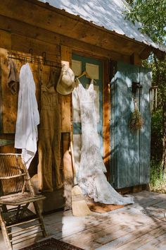 an old fashioned wooden cabin with clothes hanging outside