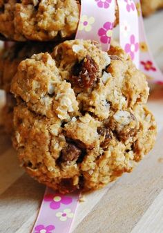 three cookies are stacked on top of each other and tied with a pink flower ribbon