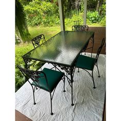 an outdoor table and chairs on a covered patio