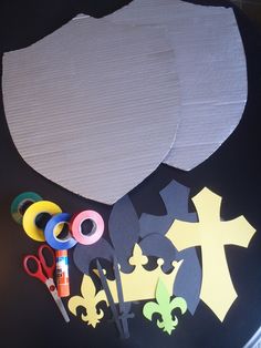 paper, scissors and other crafting supplies laid out on top of a black surface