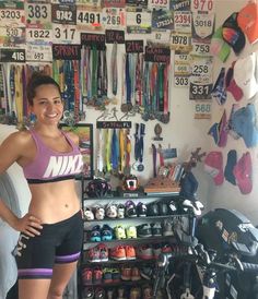 a woman standing in front of a store filled with shoes and sports gear on display