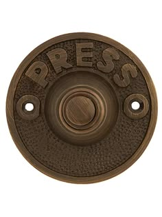 an old fashioned brass plate with the word press on it