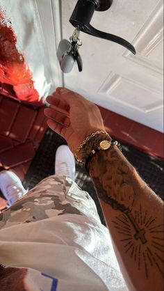 a man with tattoos on his arm and wrist