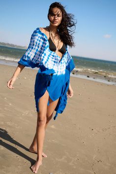 Tie-dye kimono. Open front. Short kimono sleeves. Thigh length. Loose fit. 100% Rayon. Imported. Designed in LA. Model wears size S. Blue Wrap Kimono For Summer, Blue Wrap Kimono For Beach Cover-up, Blue Wrap Kimono For Beachwear, Blue Wrap Summer Cover-up, Blue Cover-up With Kimono Sleeves For Summer, Blue Open Front Beachwear Cover-up, Blue Kimono For Beach Season, Long Blue Summer Kimono, Blue Open Front Kimono For Festival