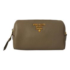 This Prada clutch is so cute and coordinates beautifully with all of Prada's Vitello Daino leather collection! The size is perfectly compact to hold your essential cosmetic items that you may want to take with you on a trip or out for the day. Throw this in your handbag or carry as a clutch and store your items classically. Features a zip closure and gorgeous gold-tone Prada emblem on the front and a black lined interior. Model: 1ND004 Argilla grey Vitello calfskin leather Gold-tone hardware Prada Milano logo Zipper closure Black fabric interior lining Measurements: 7" x 3" x 4.25" (LWH) Includes authenticity cards and dust bag Made in Italy Color: Gray. Hanging Cosmetic Bag, Prada Clutch, Large Toiletry Bag, Prada Milano, Interior Model, Prada Collection, Lipstick Bag, Mini Accessories, Cosmetic Items