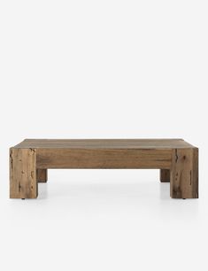 a wooden bench sitting on top of a white floor