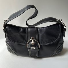 Coach Soho Style F10192 Black Leather Hobo Shoulder Bag Vintage Y2k Great Condition, With Minor Scratches/Scuffs Beautiful Vintage Coach Soho Shoulder Bag. The Black Leather Exterior Is Accented With A Buckle Detail And Zipper Closure. Measurements Approximately: 12 Inches In Width, 9 Inches In Height, And 3 Inches In Depth. Adjustable Shoulder Strap Silver Color Hardware Designer Black Baguette Bag For Everyday, Designer Black Baguette Bag With Double Handle, Shopping Leather Baguette Bag With Branded Hardware, Leather Baguette Bag With Branded Hardware For Shopping, Designer Black Baguette Bag With Branded Hardware, Black Baguette Bag With Branded Hardware For Travel, Leather Baguette Bag With Branded Hardware And Double Handle, Leather Baguette Shoulder Bag With Branded Hardware, Trendy Coach Leather Satchel