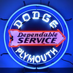 a neon sign that says dodge plymouth with an arrow pointing to the right in front of it