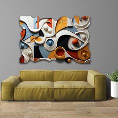 an abstract painting on the wall above a couch in a room with wood flooring