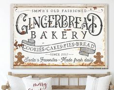 an old fashioned gingerbread bakery sign hangs on the wall above a bed with two pillows