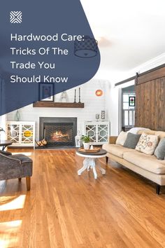 a living room filled with furniture and a fire place in the middle of a wooden floor