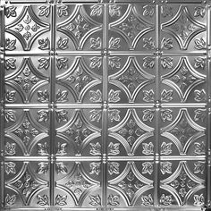 an image of a metal wall with decorative designs on the front and back panels in silver