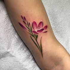 a close up of a person's foot with a flower tattoo on the leg