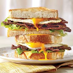 a grilled cheese sandwich with bacon, lettuce and egg