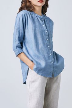 "Indulge in luxury and sophistication with our Blue Linen Button Up Shirt. Crafted from exquisite linen, this casual shirt exudes elegance and comfort. The oversized fit and classic button-up design make it a versatile addition to any wardrobe. Treat yourself or surprise her with this perfect gift. ★★FEATURES Pure linen shirt Round Shirt Collar Women's linen shirt Linen Button Down Shirt Half-sleeve shirt Pleated back Side split Soft and comfortable linen shirt Loose fit linen shirt Oversized linen shirt Classic linen shirt, simple linen shirt Summer shirts, spring shirts ★★Mode size Height 170cm (5′ 7″) Bust 84 cm (33\") Waist 66 cm (26\") She wears size XS. ★★ Bespoke Order Service If you Request other color Request the length Your height is not between 155 cm- 172 cm Your weight is over Relaxed Fit Light Blue Blouse With Pockets, Blue Shirt With Rolled Sleeves For Daywear, Light Blue Tops With Button Cuffs And Spread Collar, Light Blue Summer Tops With Button Cuffs, Elegant Oversized Shirt With Pockets, Light Blue Tops With Button Cuffs For Daywear, Blue Relaxed Fit Blouse With Cuffed Sleeves, Blue Blouse With Relaxed Fit And Cuffed Sleeves, Blue Blouse With Cuffed Sleeves Relaxed Fit