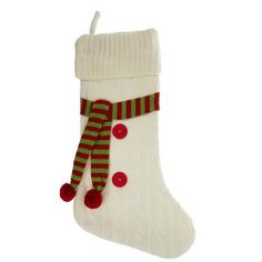 a white christmas stocking with red and green pom poms