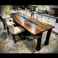 a large wooden table sitting in the middle of a kitchen