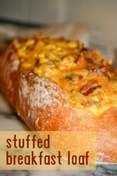 the bread has been stuffed with cheese and other toppings on it, along with text that reads stuffed breakfast loaf