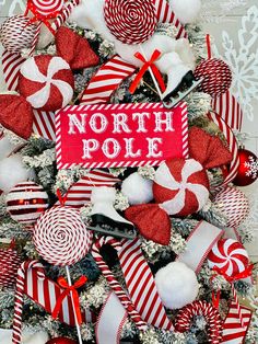 a christmas tree decorated with red and white candy canes, lollipops, marshmallows