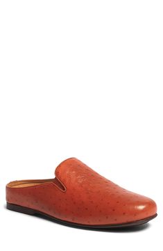 Ostrich-embossed leather adds a luxe appeal to this slip-on mule grounded by a grippy rubber sole. Plain toe Slip-on style Leather upper and lining/rubber sole Imported Classic Slip-on Mules With Textured Footbed, Classic Leather Mules With Textured Sole, Formal Leather Mules With Textured Sole, Leather Slip-on Mules With Textured Footbed, Brown Slip-on Mules With Textured Sole, Leather Slip-on Slippers With Textured Footbed, Brown Textured Sole Slip-on Mules, Brown Leather Slippers With Textured Sole, Leather Slip-on Mules With Textured Sole