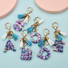 the letters are decorated with flowers and tassels to spell out the word abc