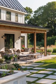 a patio with chairs and tables in front of a house