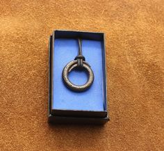 an open box with a metal ring in it