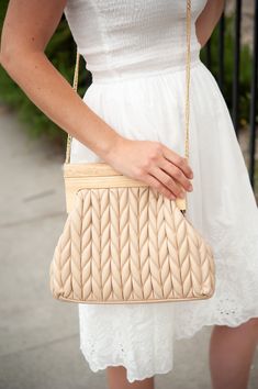 The Rachel quilted clutch is a stylish and versatile handbag that is perfect for an upscale occasion. Featuring a wooden handle closure, this bag is both functional and fashionable, offering a unique and eye-catching design. The soft leather chevron quilting adds a touch of elegance and sophistication to the bag, while the spacious interior provides plenty of room for all your essentials. Whether you're heading to a special event or a casual outing with friends, the Rachel quilted clutch is the Chic Quilted Evening Clutch, Spring Beige Clutch Evening Bag, Beige Clutch Evening Bag For Spring, Chic Beige Clutch With Top Carry Handle, Chic Quilted Clutch For Everyday Use, Spring Clutch With Detachable Handle, Beige Quilted Evening Bag, Chic Quilted Clutch Bag, Cotton Boho Dress