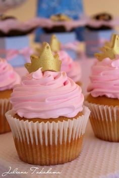 cupcakes with pink frosting and a gold crown on top