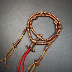 This mala was collect from Hepo Town Baiyu County Tibet, blessed in Yaqing Monastry. It is made of copper,brown color,length is 44cm / 18,has 1 Kartika ,2 skeletons, 2 stamp pendant, and 2 strings of counters with phurba + kartika. Adjustable Brown Mala For Festival, Traditional Brown Jewelry For Blessing, Bronze Spiritual Necklaces For Rituals, Spiritual Copper Necklace For Meditation, Brown Necklace With 108 Beads For Festivals, Adjustable Copper Spiritual Necklaces, Spiritual Adjustable Copper Necklace, Spiritual Bronze Necklaces For Festivals, Bronze Spiritual Necklaces For Festivals