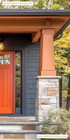 an orange front door on a house with steps leading up to it and trees in the background