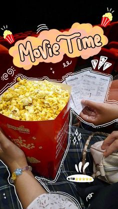 a person holding a box of popcorn in front of a movie theater screen with the words movie time above it