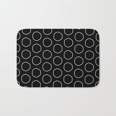 a black and white bath mat with circles on it