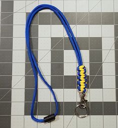 Blue and yellow lanyard with removable keychain, and safety breakaway. Hand made Lanyard perfect for holding I.D. Badges, keys and much more. These are extremely light weight and comfortable to wear. The buckle allows the end to be detached and re-attached for use with keys, cardswipes, or other items without having to remove the neck lanyard. These lanyards are a unique and functional gift that can be given in traditional settings (birthdays, anniversaries, holidays, special occasions, etc...). They can also work as party favors, teacher gifts, good luck, team or school spirit gifts, Boy/Girl Scout Troop event gifts, and much, much more - really limited only by your imagination. Show your support for a cause that is important to you with a customized paracord lanyard. From celebration to Blue Lanyard With Key Leash For Personal Use, Adjustable Lanyards With Swivel Clip For Everyday Use, Adjustable Lanyard With Swivel Clip For Everyday Use, Adjustable Lanyards With Key Clip For Personal Use, Blue Lanyards With Key Leash As Gift, Blue Lanyard With Key Leash For Gift, Blue Lanyard With Key Leash As Gift, Adjustable Lanyard With Lobster Clasp For Personal Use, Adjustable Lanyards With Lobster Clasp For Everyday Use