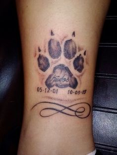 a dog's paw with the name and date tattooed on it