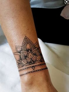 a woman's foot with a tattoo on it and a lotus flower in the middle