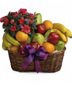 a basket filled with lots of fruit and flowers